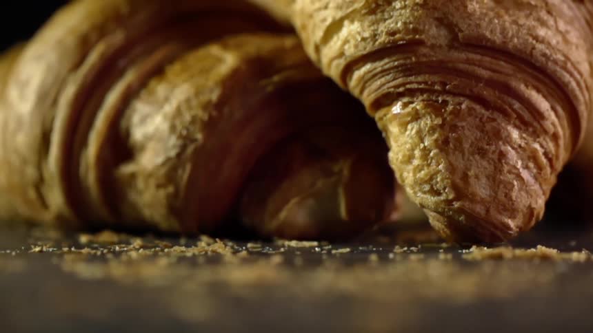 Croissants and crumbs on a tabletop