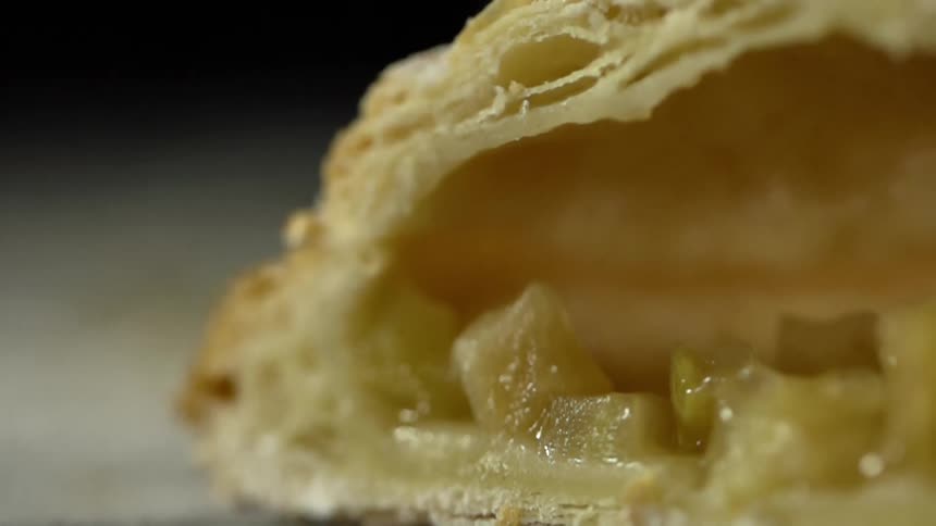 Chunks of apple sit inside a turnover