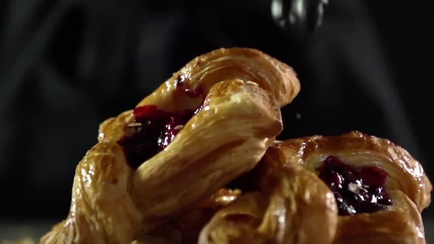 A person sets a pastry down