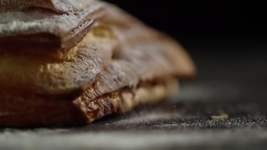 A loaf of bread landing on a counter