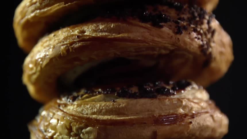 A stack of baked pastries with toppings
