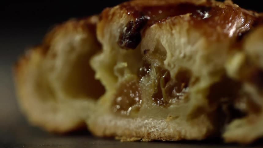 A puff pastry treat is cut to reveal a jam filling