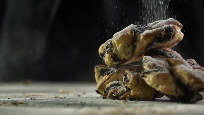 Powdered sugar is poured on the pastries