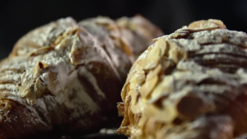 Bread and pastries sitting on a counter