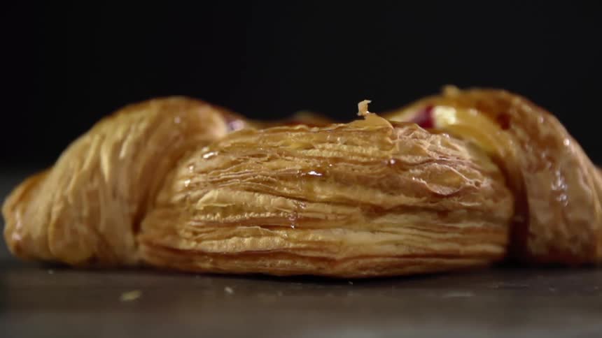 Bread that is laying on a table with crumbs