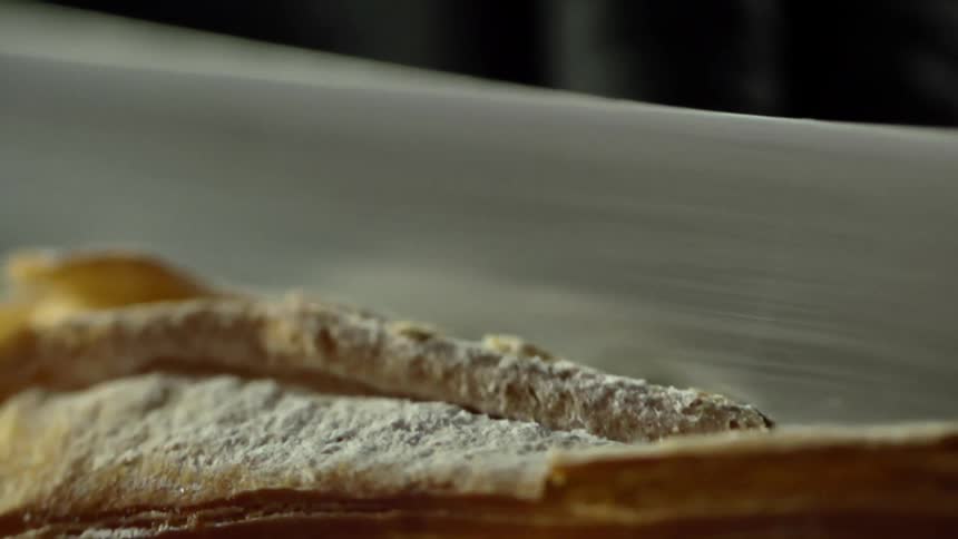 A piece of bread is being sliced