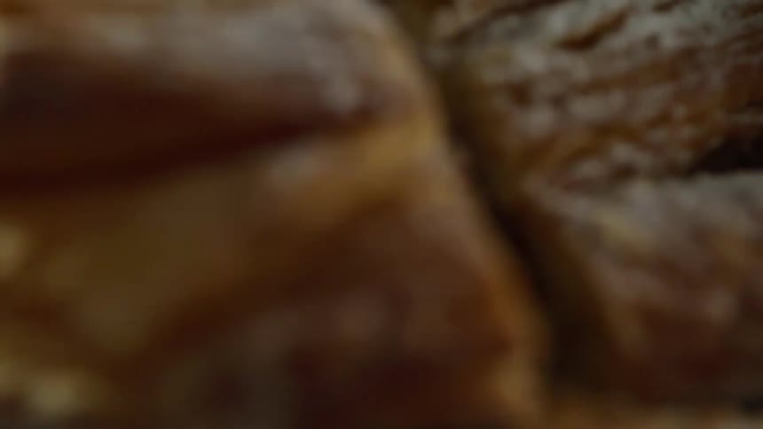 A pastry is cut in half to reveal apple filling