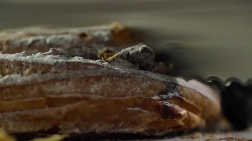 Serrated knife slices a piece of pastry