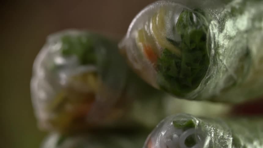 Spring roll filled with vegetables is picked off from top of stack