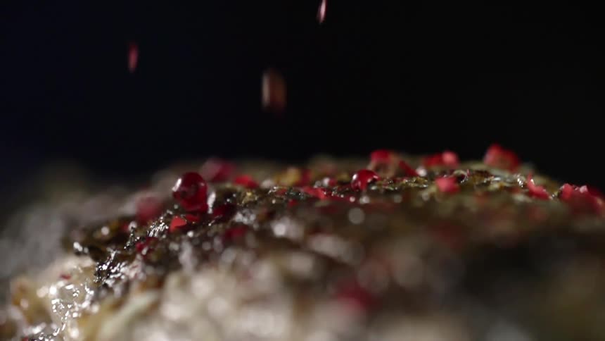 Seasoning being added to food
