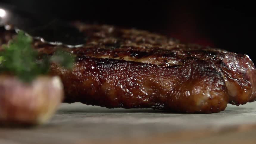 A large piece of meat being set down