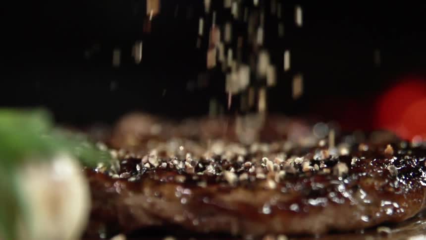 Seasoning is poured on the meat
