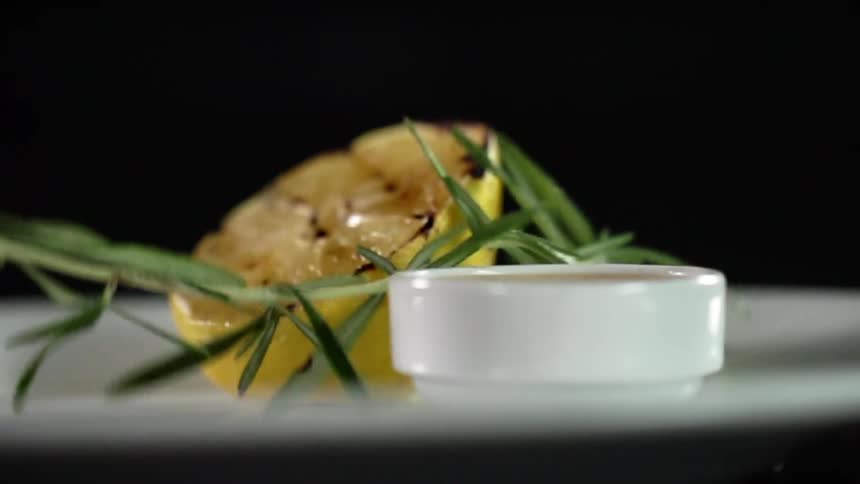 Garnish is dropped on the grilled lemon half