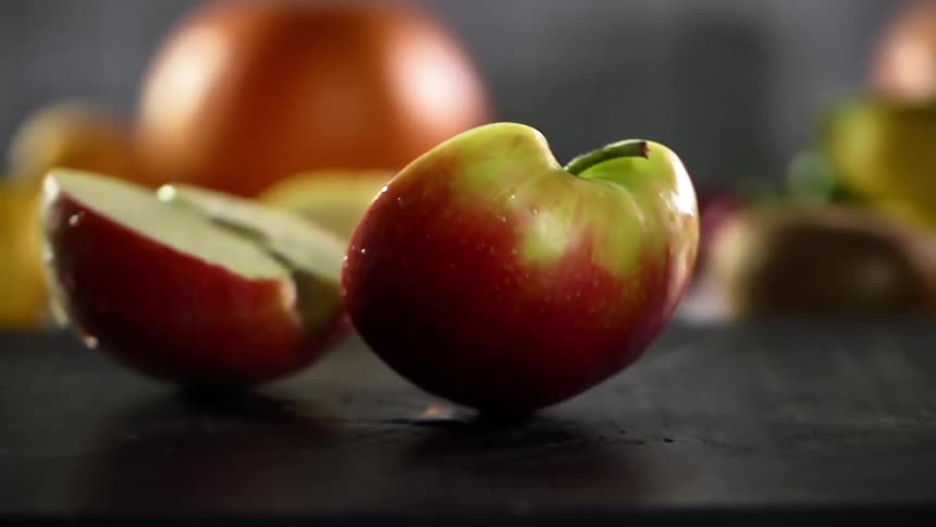 A person sets a cut apple down