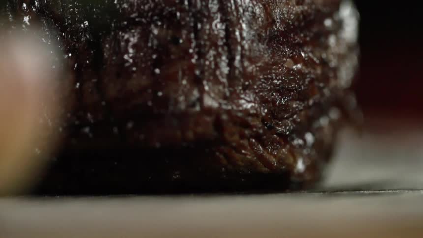 Cooked beef falls onto a table