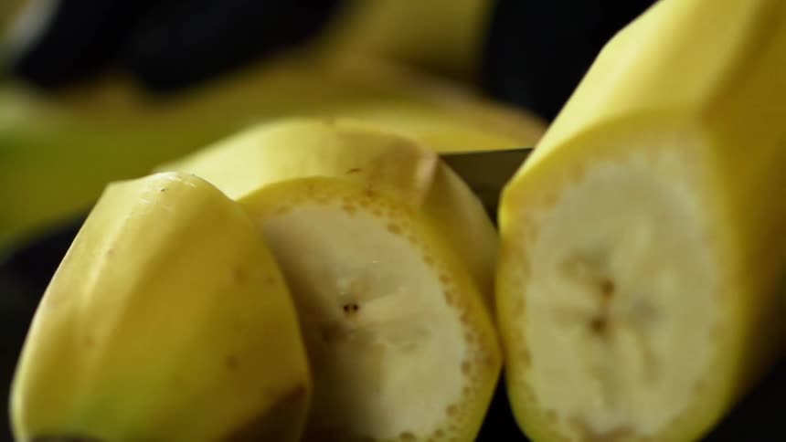 A banana is being sliced into small pieces