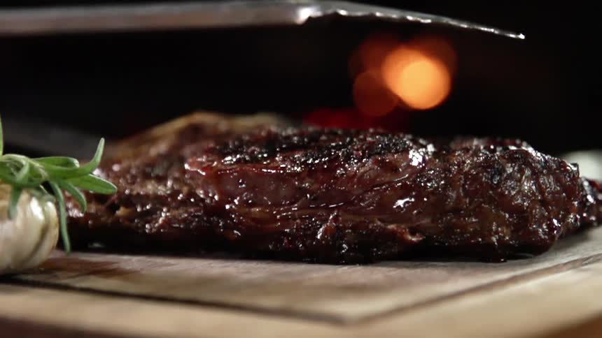 The large steak is laid on the table