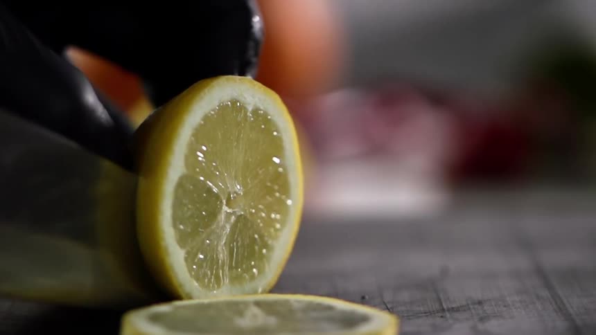 A person slicing a lemon