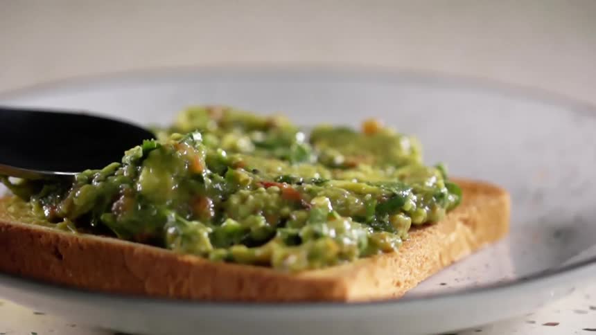 Food is spread on a piece of toast
