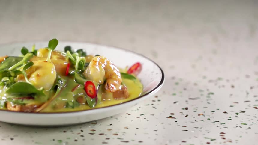 Garnish is dropped on the meal