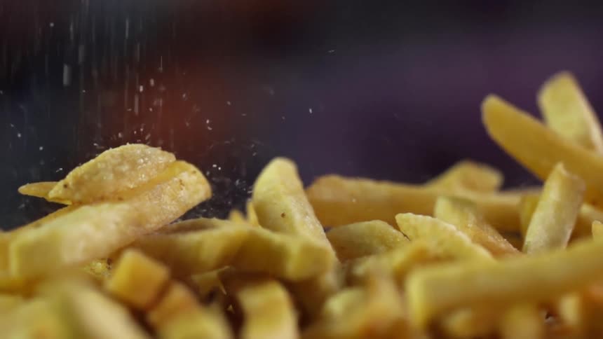 A pile of french fries seasoned with salt