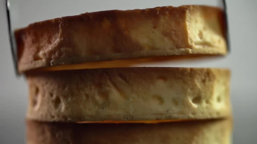 A round cake is stacked on the table