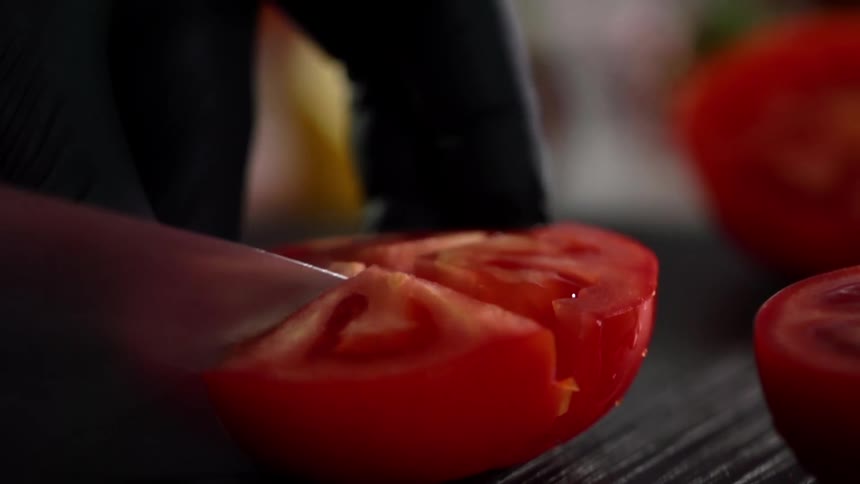 A tomato is cut into four wedges