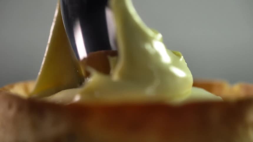 Cream being put on a dessert