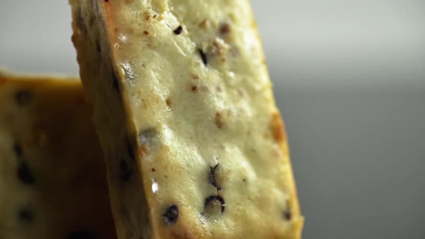 A baked dessert sits on a reflective surface