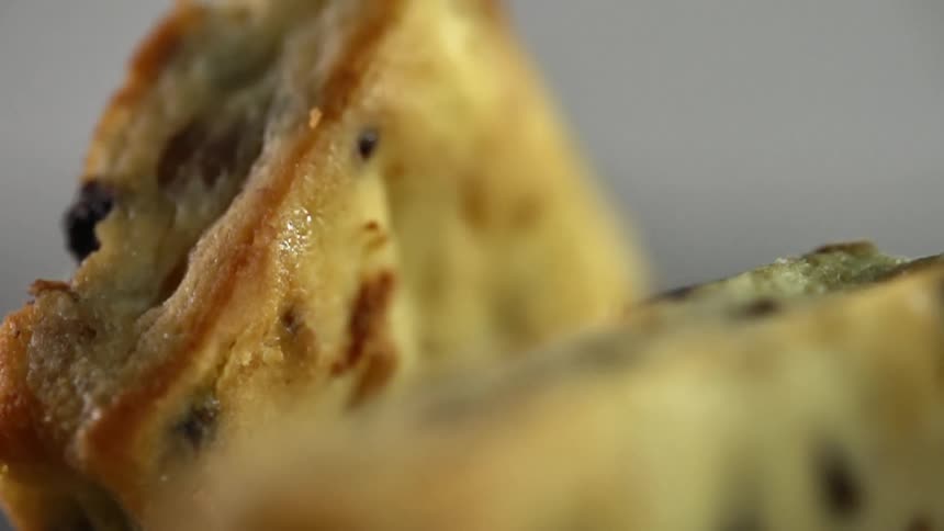 Two raisin scones are placed next to each other in different positions
