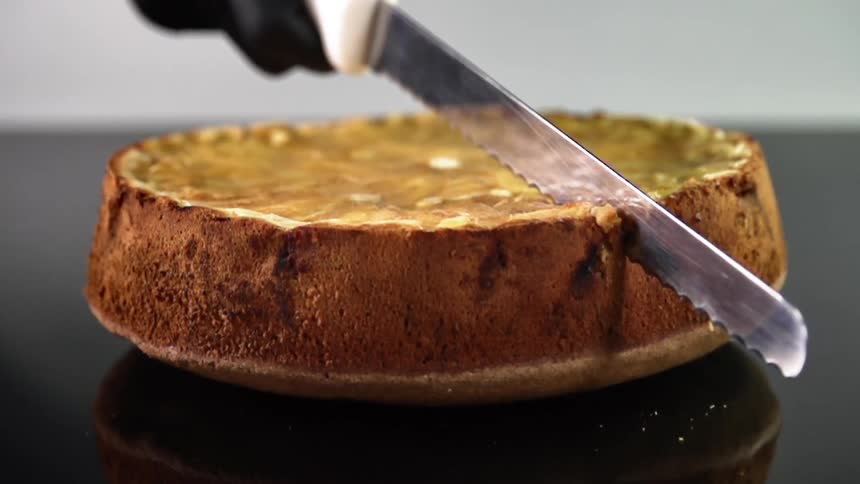 A person cuts in to a cake