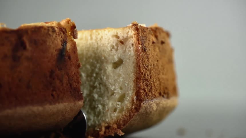 A knife cuts through a baked good