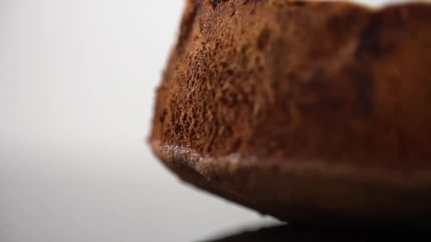 A brown piece of bread sits on a counter top