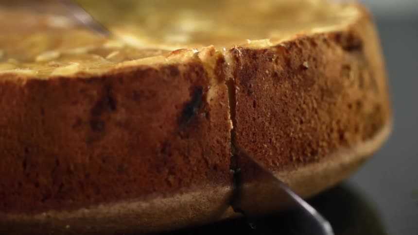 Close up of cornbread being cut by a bread knife