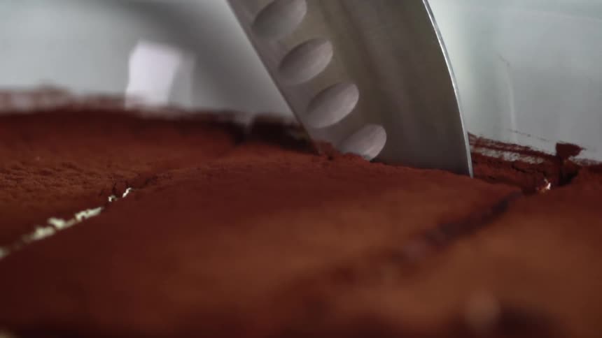 Kitchen knife slices chocolate cake