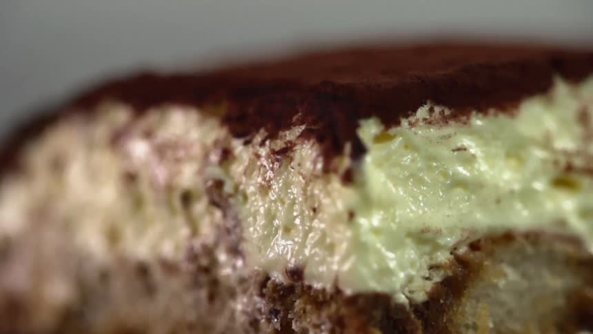 Slice of cake topped with cream an chocolate powder