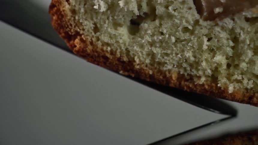 Placing a slice of cake over a reflective surface usning a spatula