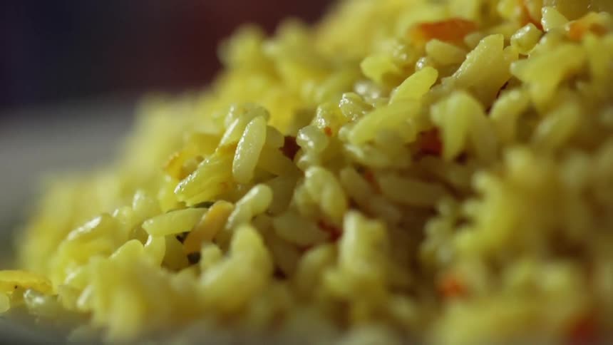 A pile of yellow rice is on the plate
