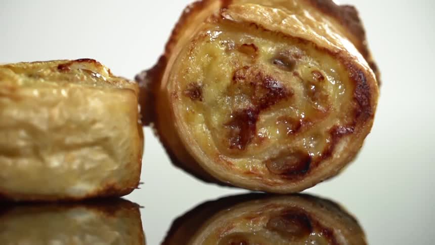 Two glazed pastries sit on a counter top