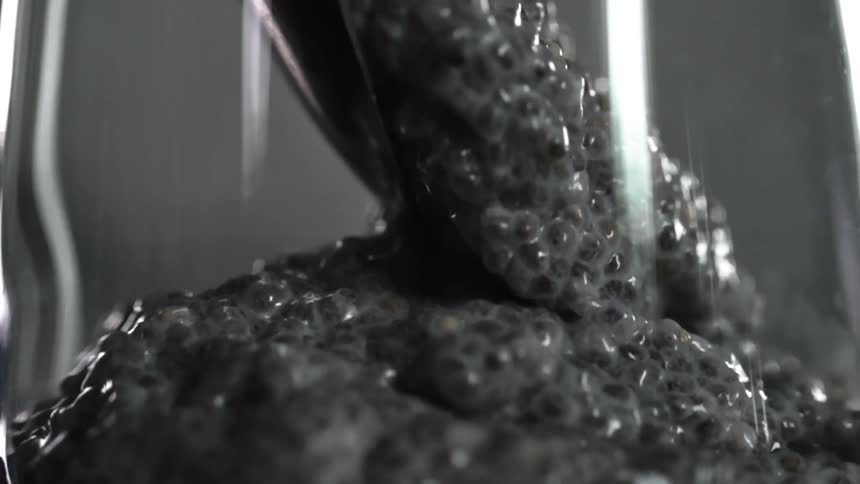 Chia seed pudding is spooned into a glass