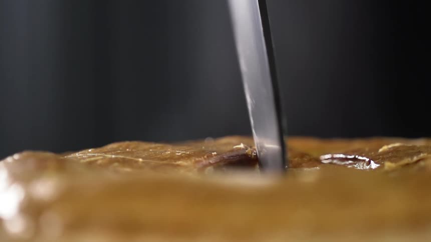 A knife is being used to cut the cake