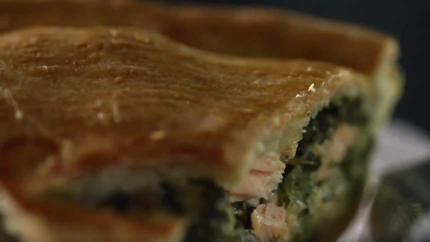 A slice of pot pie filled with chicken and vegetables