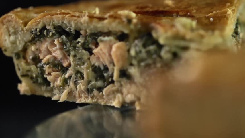 A slice of food is removed from the tray