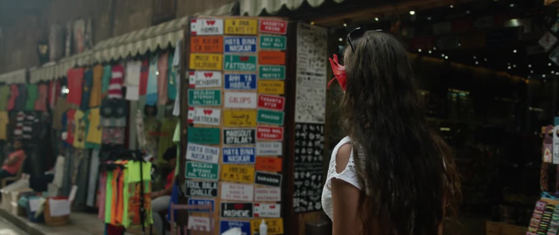 A woman walking past a storefront