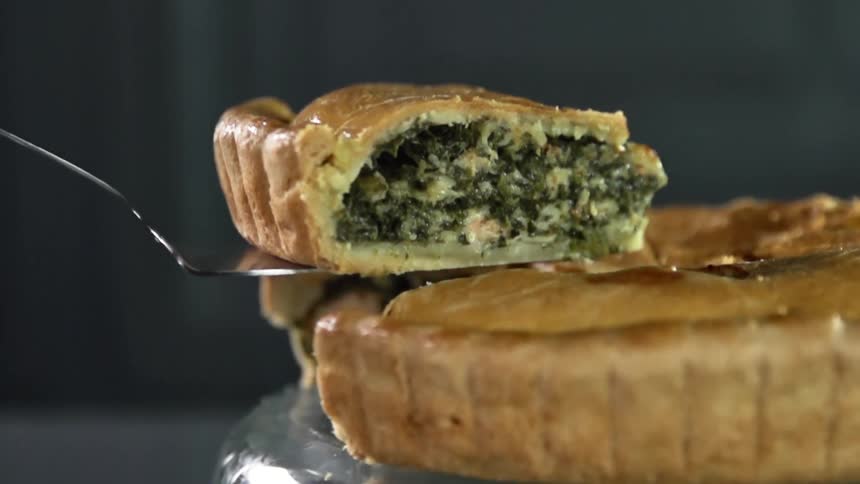 A slice of pie is lifted with a utensil