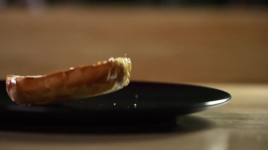 Toasted half bun falls onto a black plate