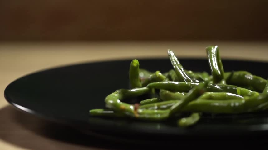 Asparagus falling onto a plate