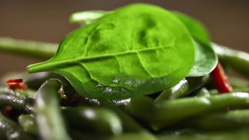 Spinach leaves falling on top of asparagus