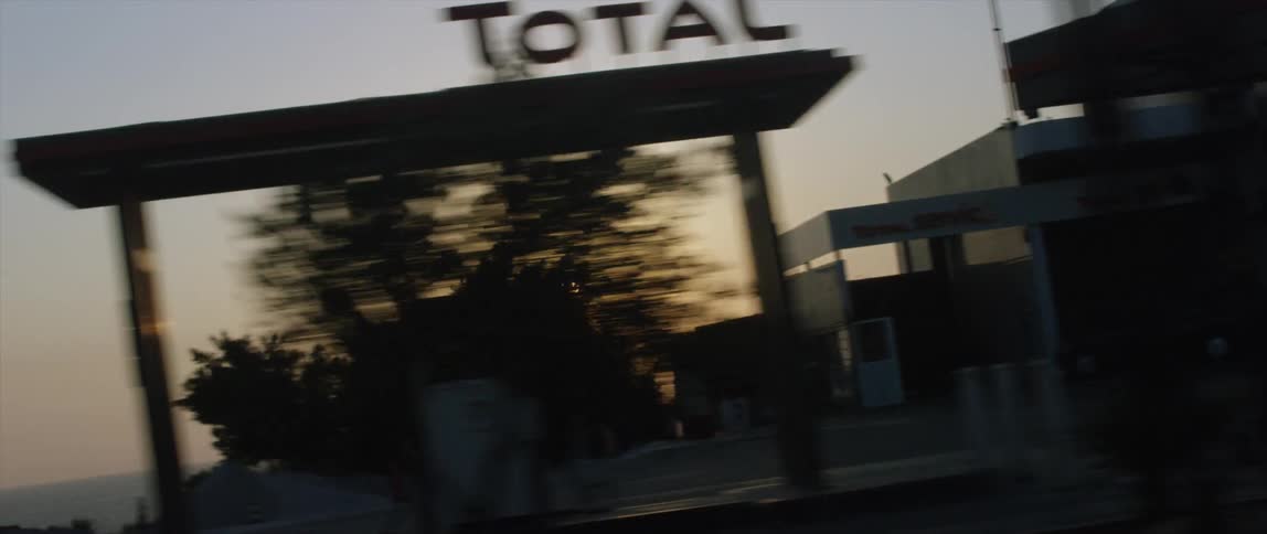 Traveling past some stores and the beach at sunset