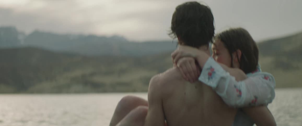 A man carries a woman in the water